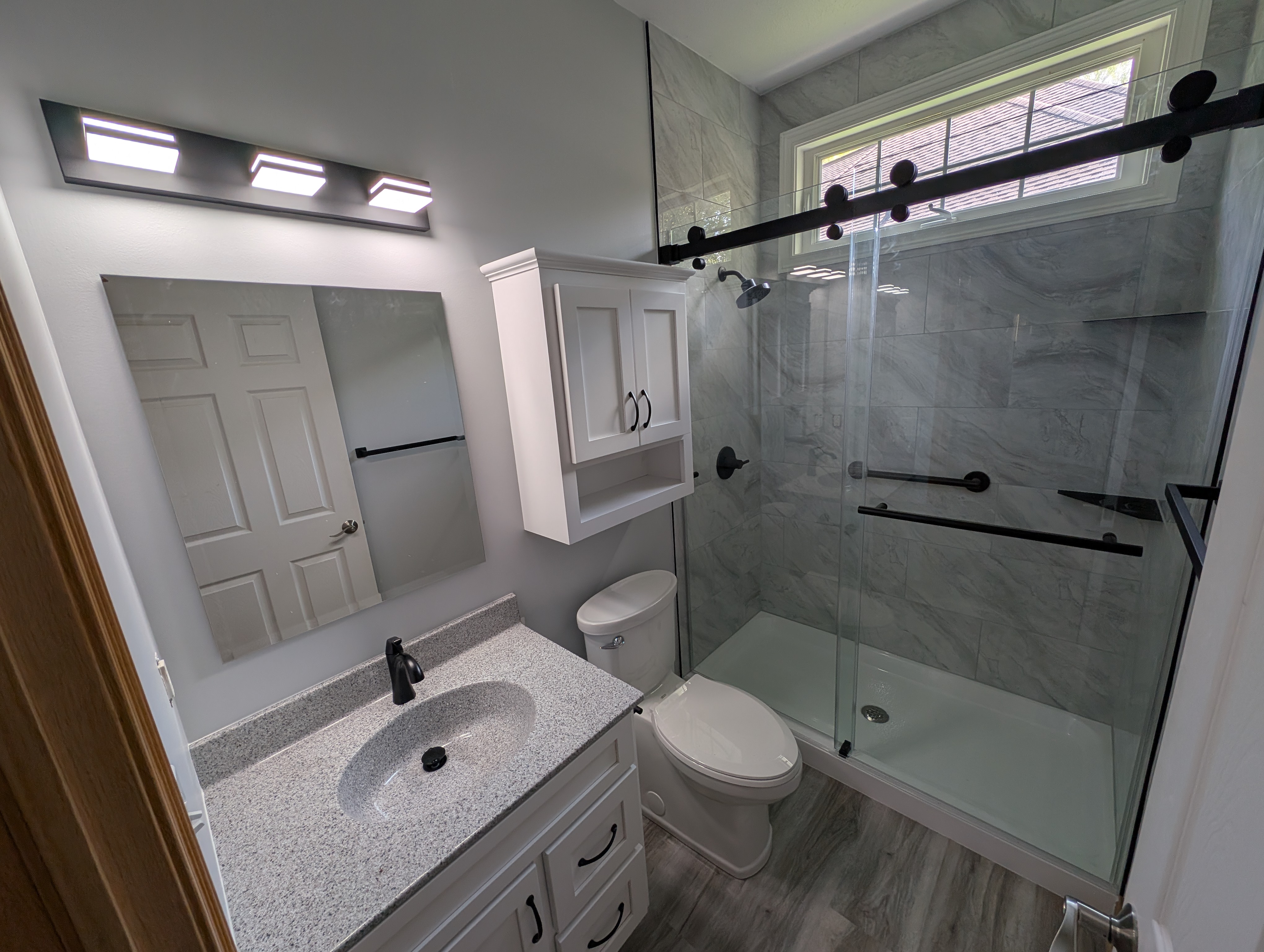 Modern bathroom with custom tile and warm wood tones
