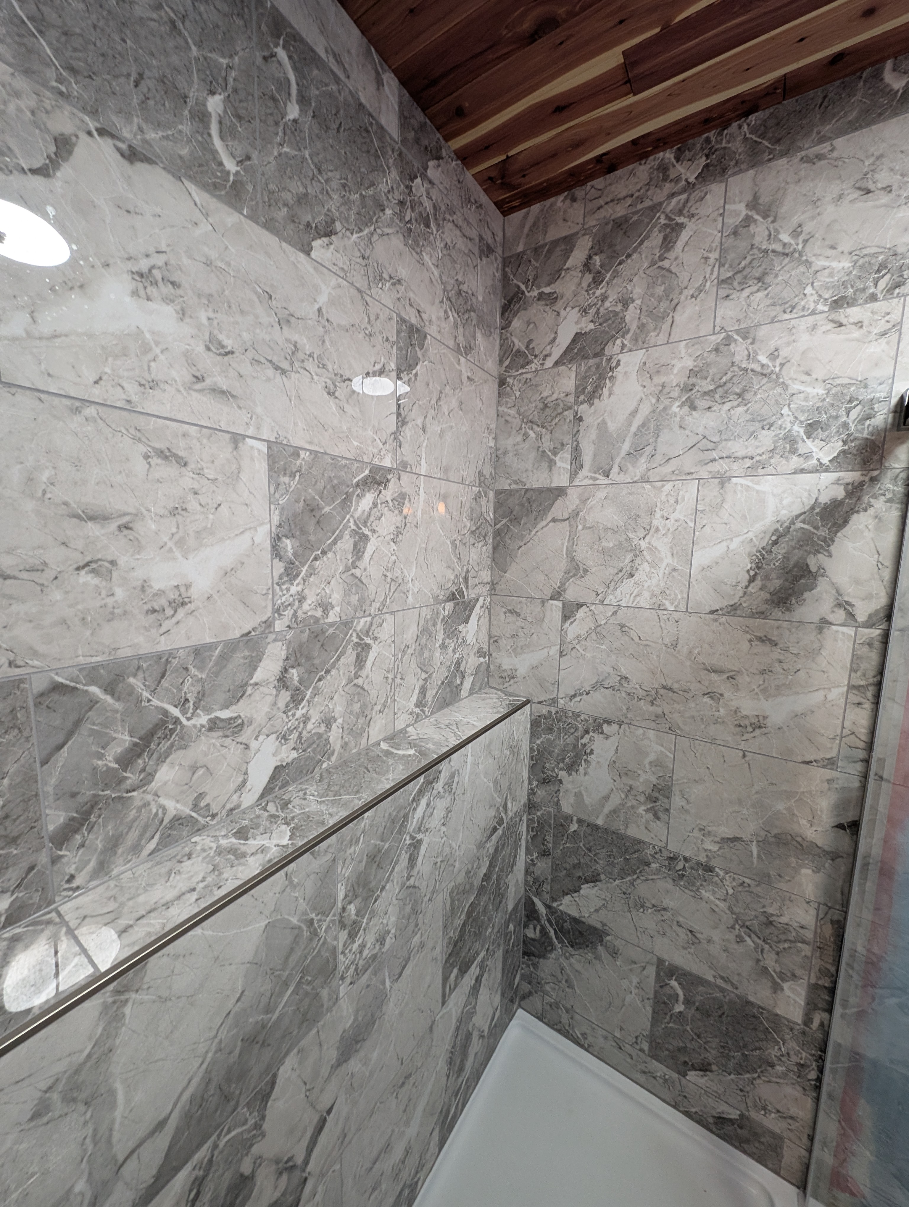 Tile shower with bold pattern and glass enclosure